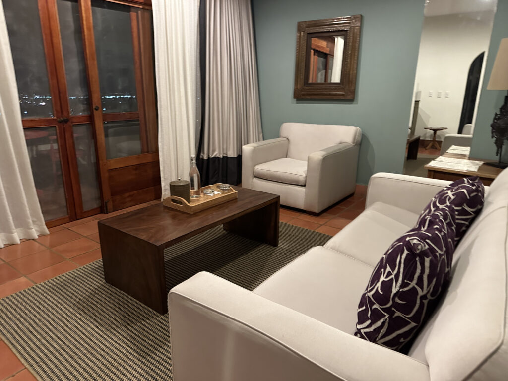 a living room with white couches and a coffee table