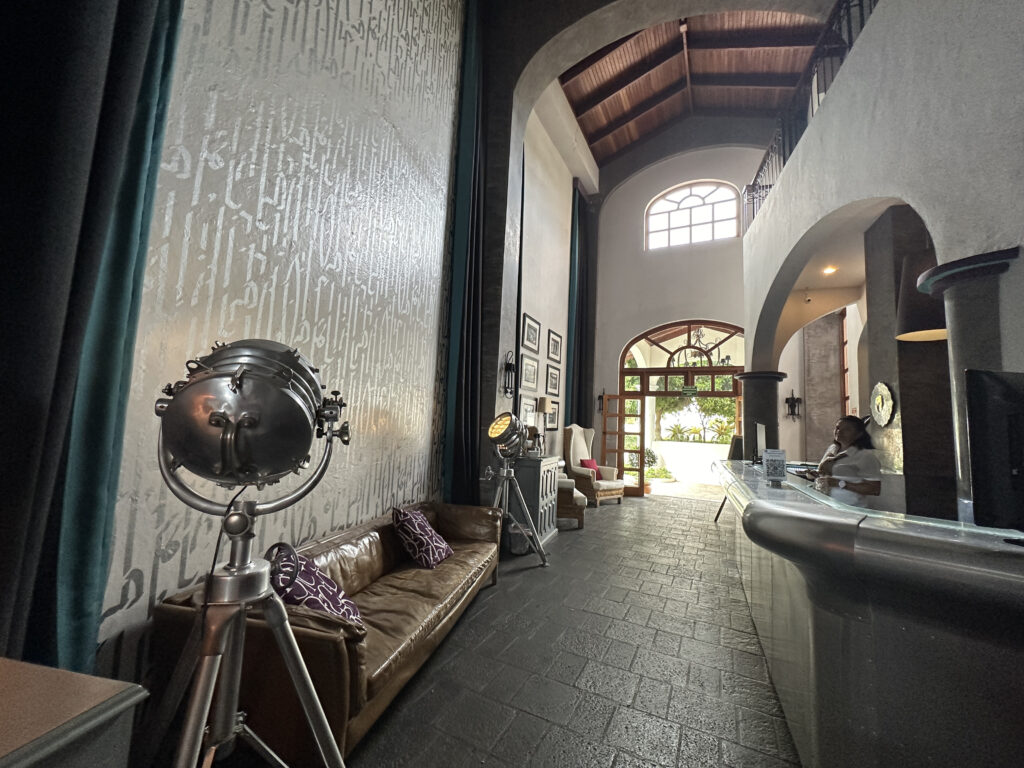 a reception area with a couch and a mirror