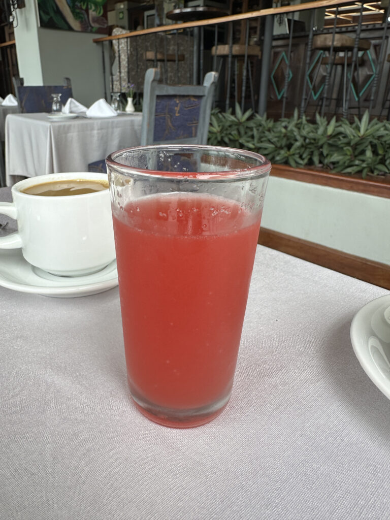 a glass of red liquid on a table
