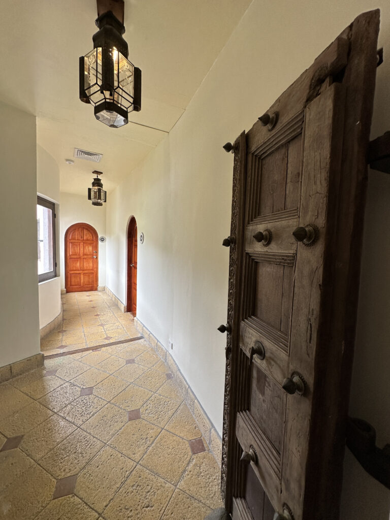 a hallway with a door and a light from the ceiling