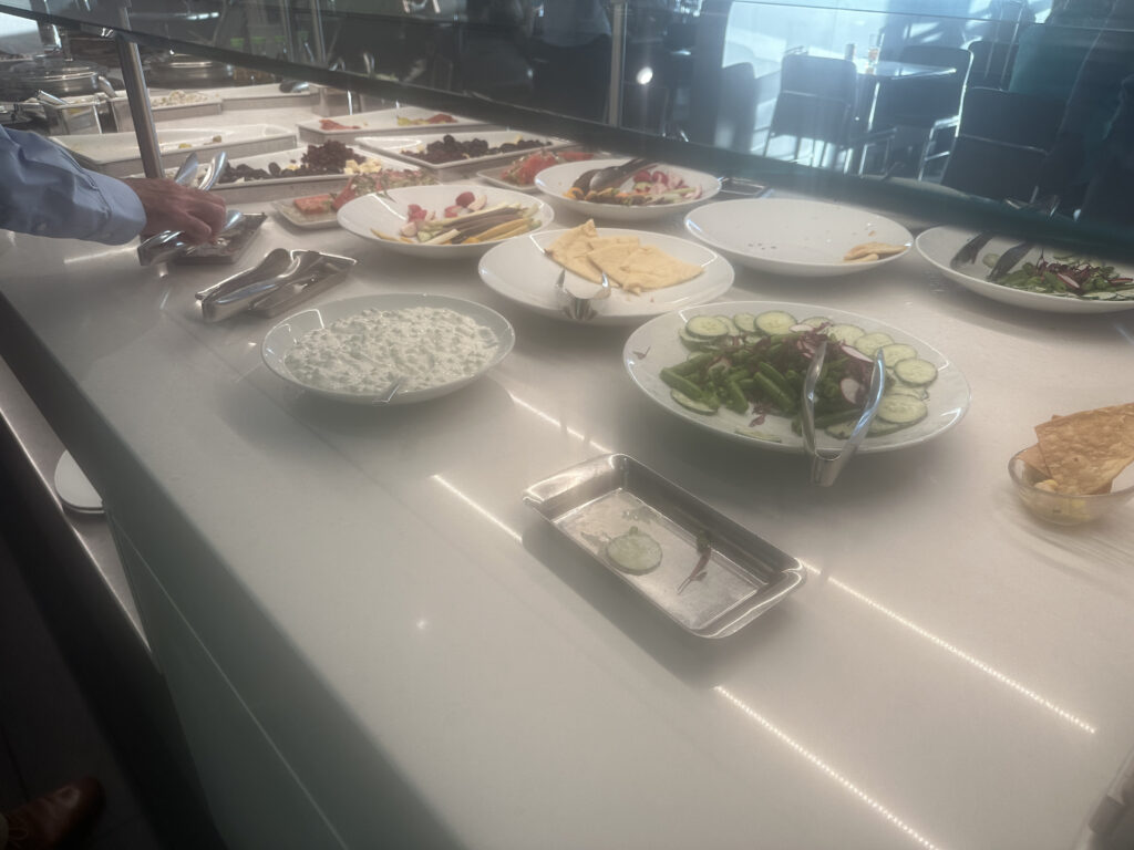 a buffet table with plates of food