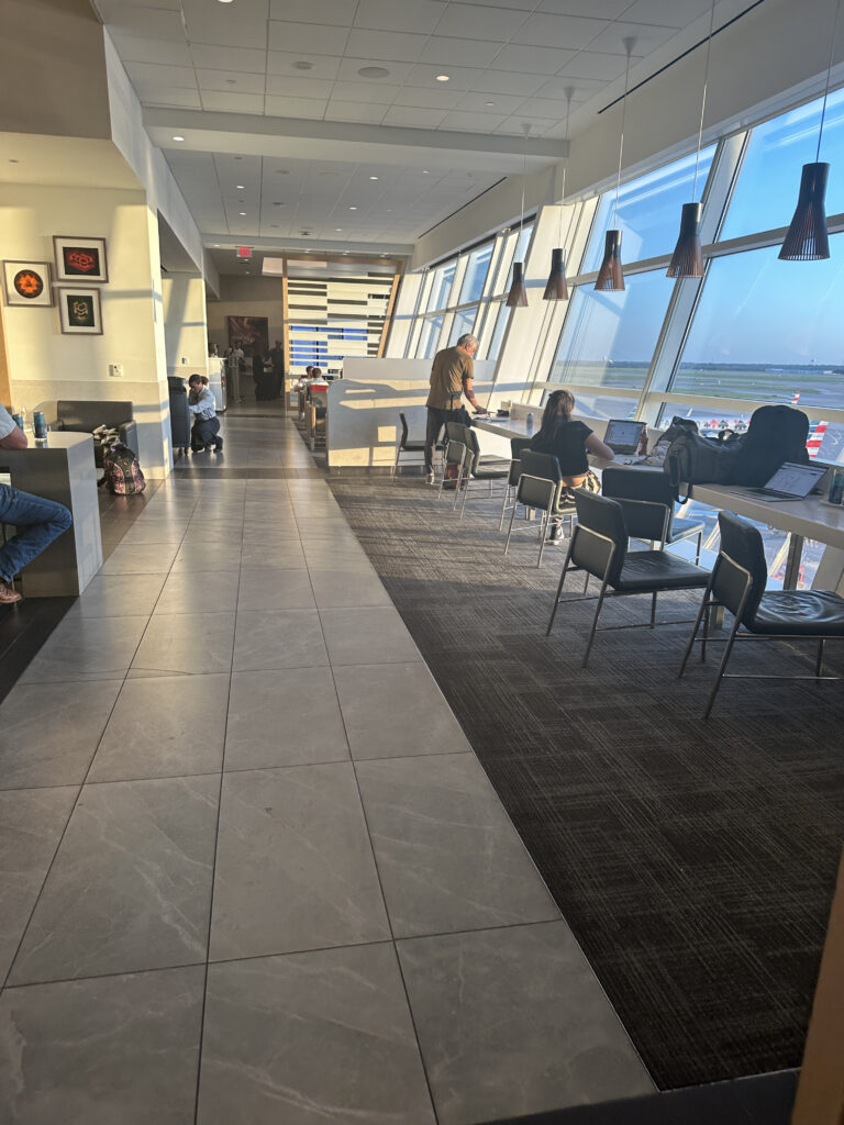 a group of people sitting in a room with windows