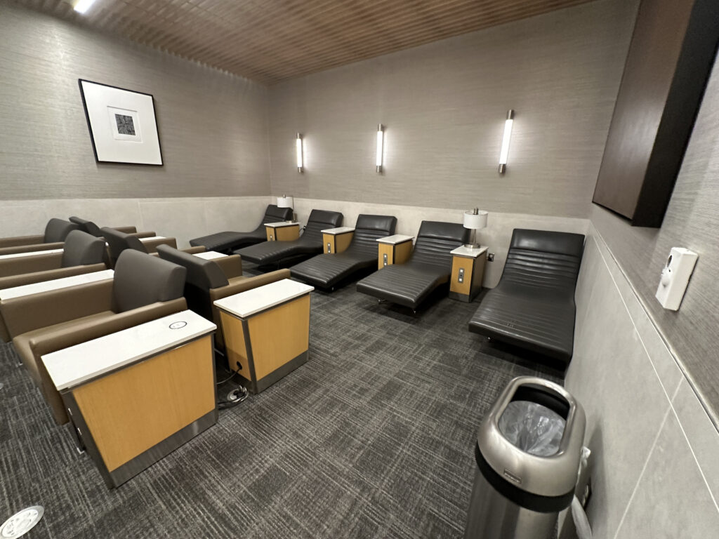 a room with chairs and a trash can