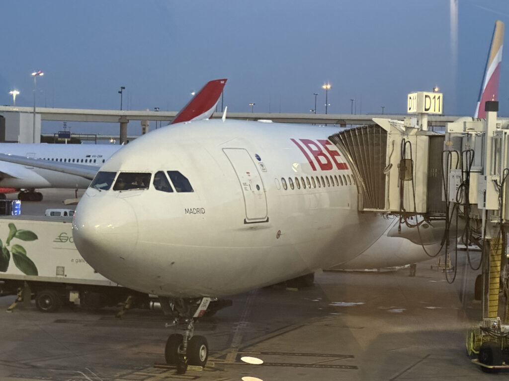 a white airplane with red tail and a red tail and a red tail