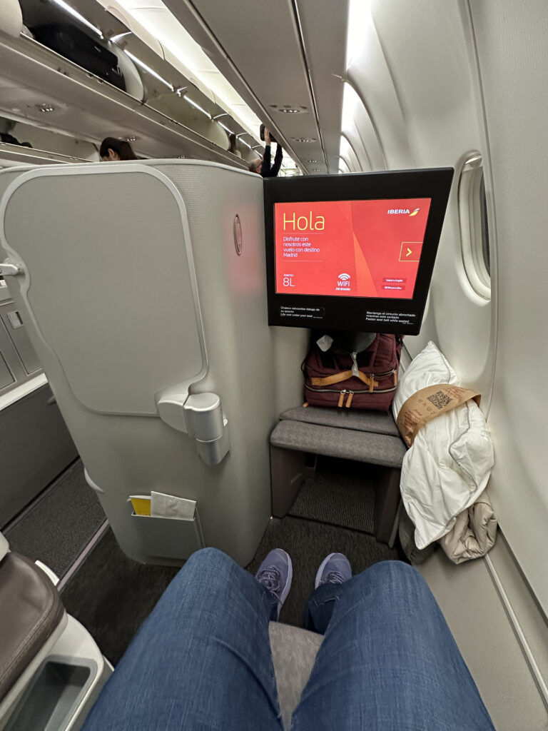 a person's legs in a chair on an airplane