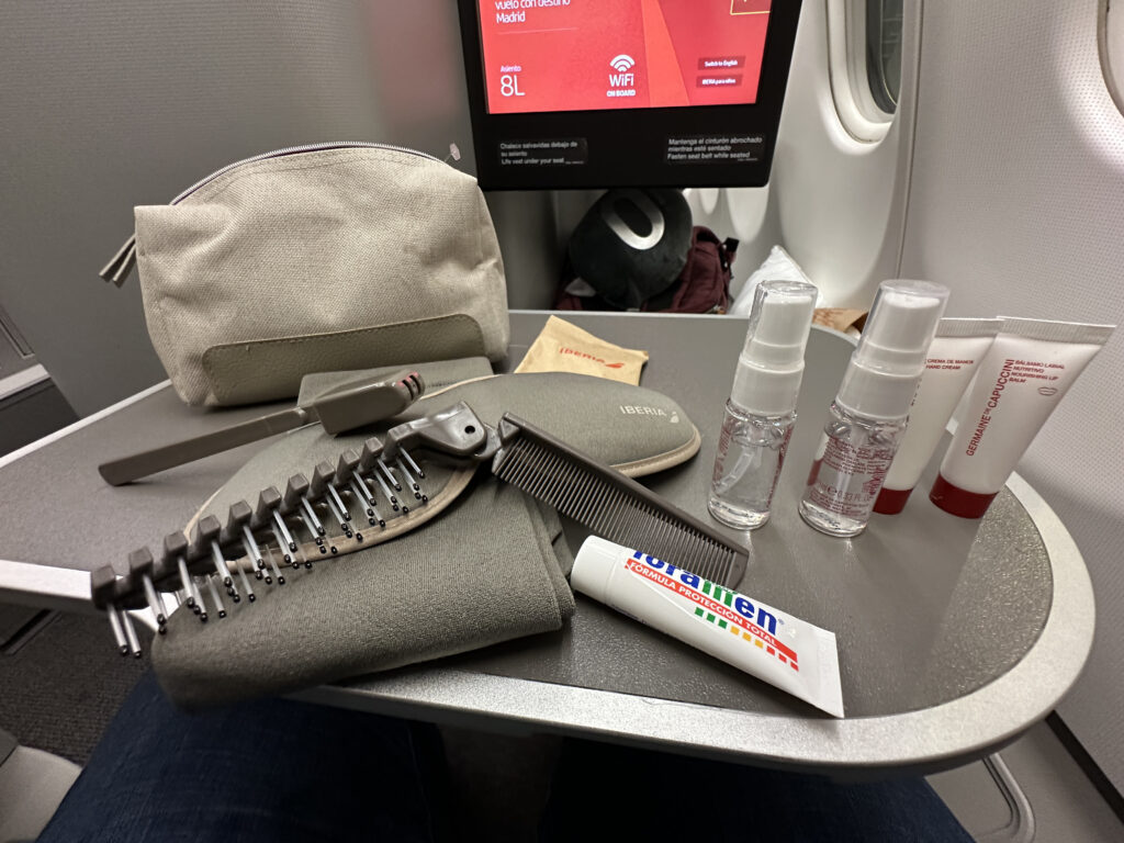 a table with a bag and a comb and a bottle of shampoo