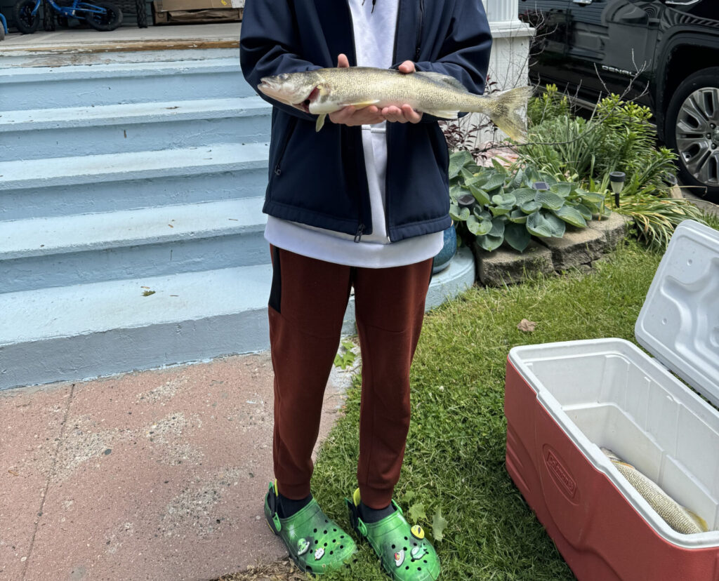 a boy holding a fish