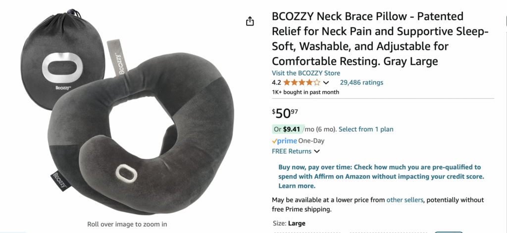 a black neck pillow with a white label