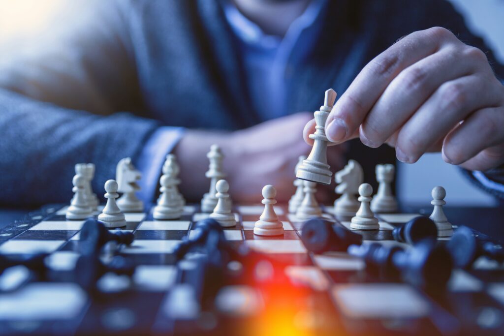 a person playing chess with a chessboard