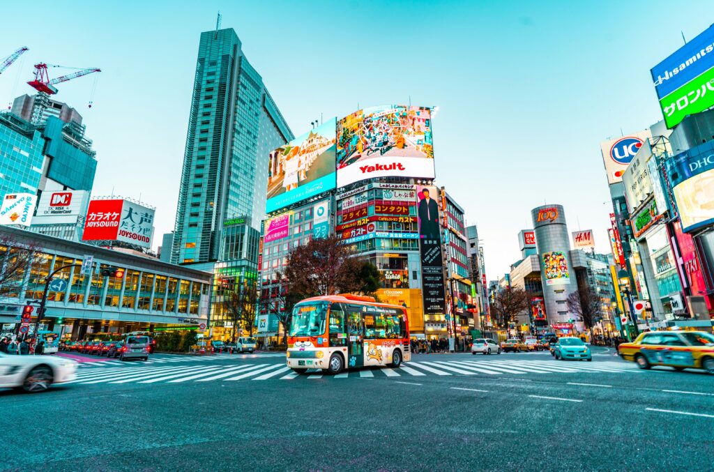a city street with buildings and a bus