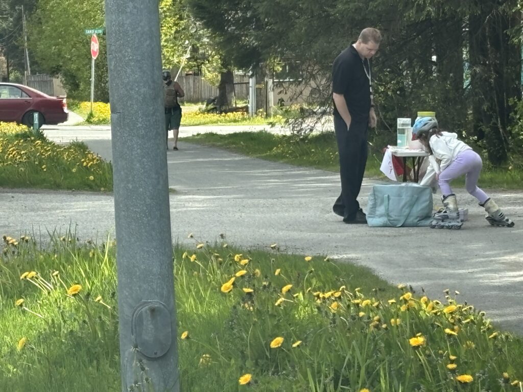 a man standing next to a woman sitting on a bench