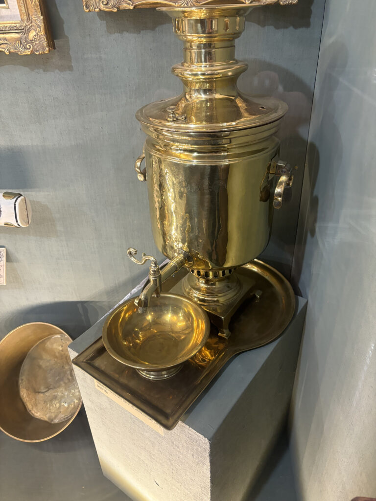 a gold urn and bowl on a pedestal