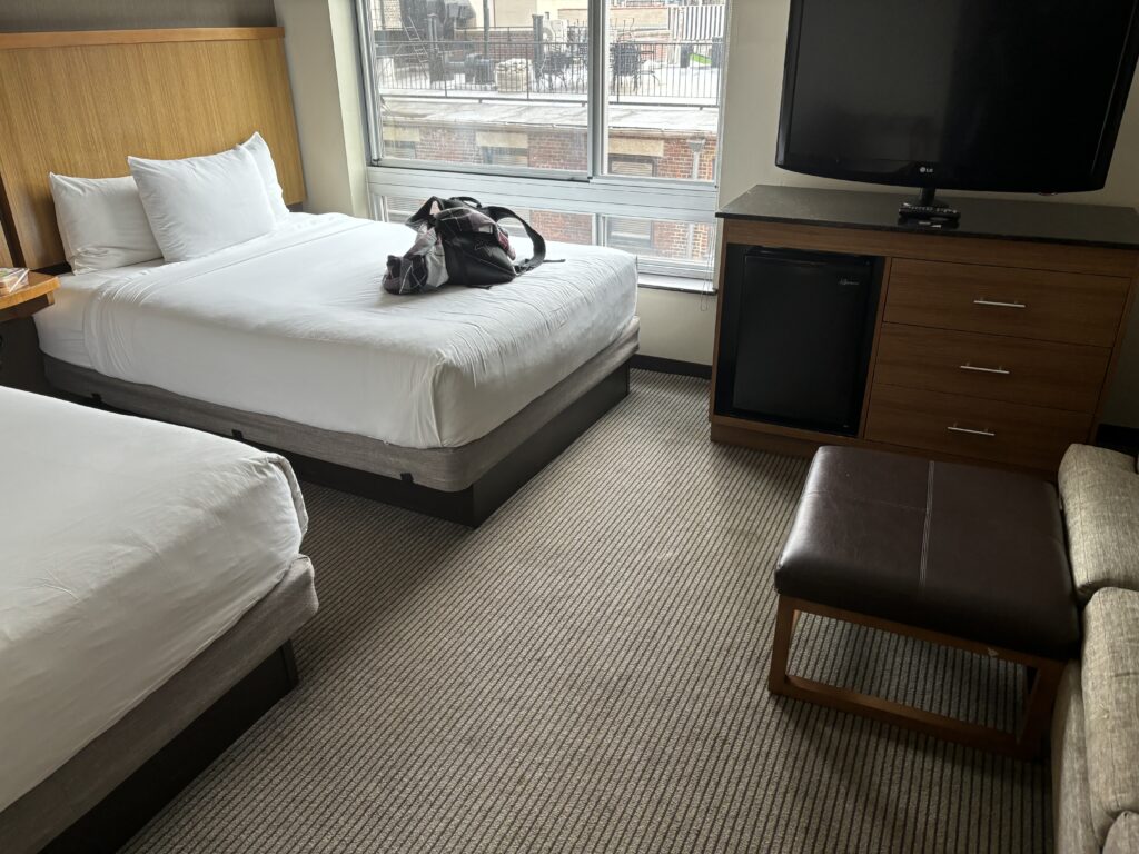a room with a bed and a television