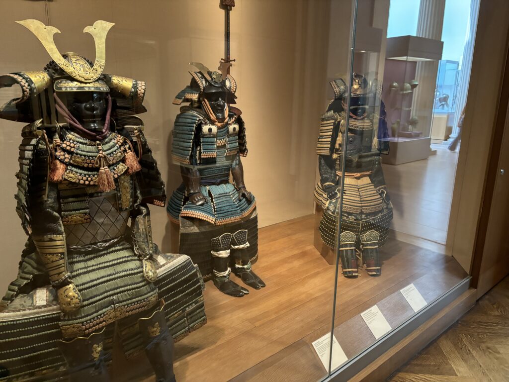 a group of armors in a glass case