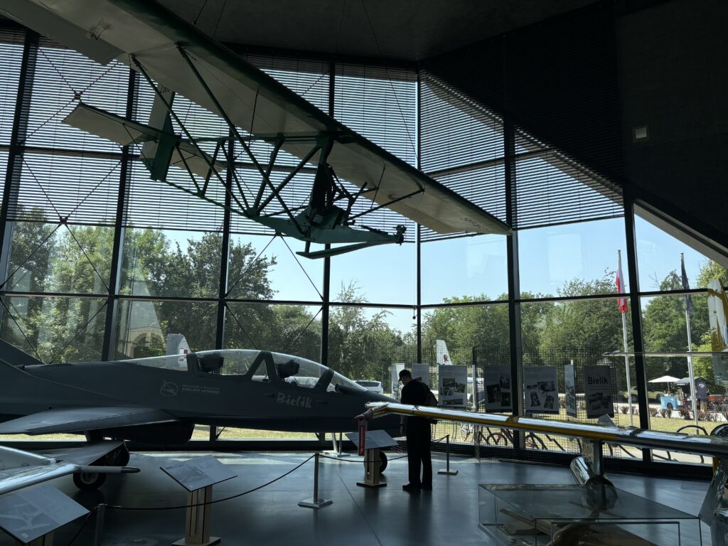 a man standing in a room with a plane in front of it