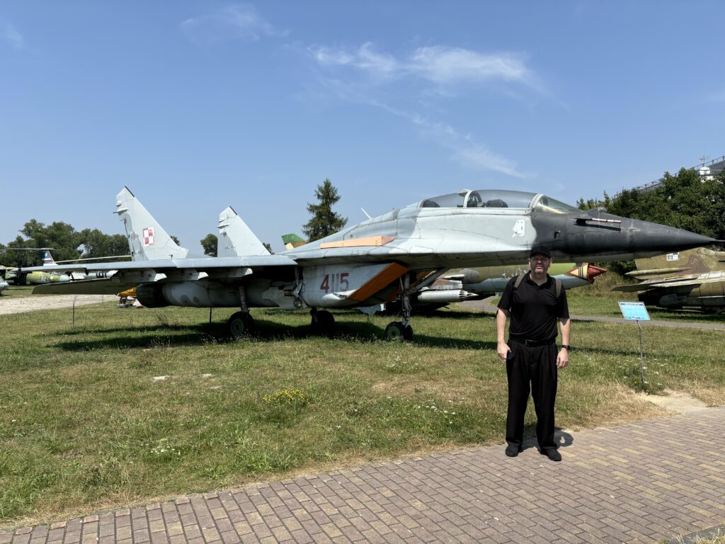a man standing in front of a fighter jet