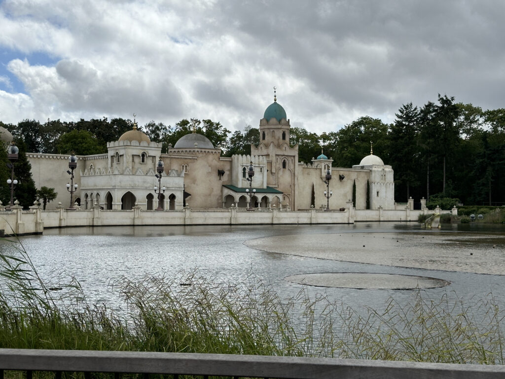 a building with a pond and trees