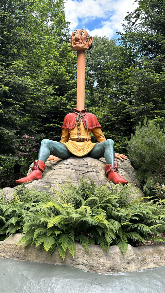 a statue of a man sitting on a rock