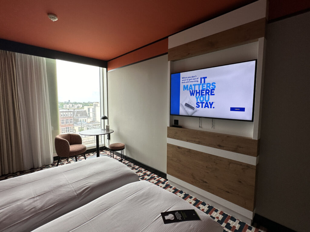 a room with two beds and a tv