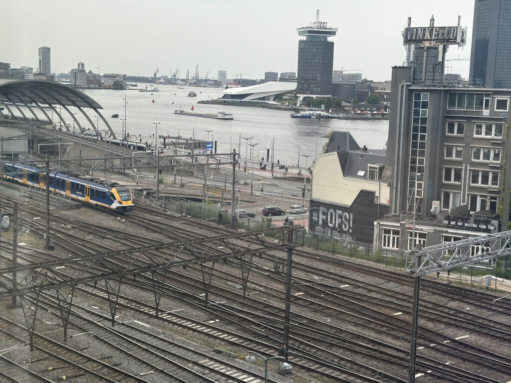 a train on the tracks by a body of water