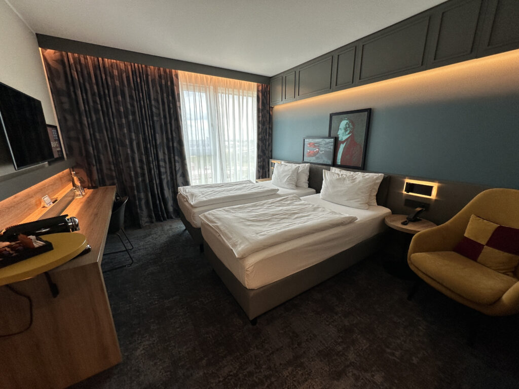 a room with two beds and a desk