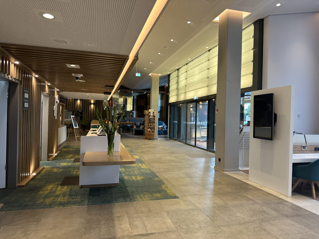 a lobby with a tv and a table
