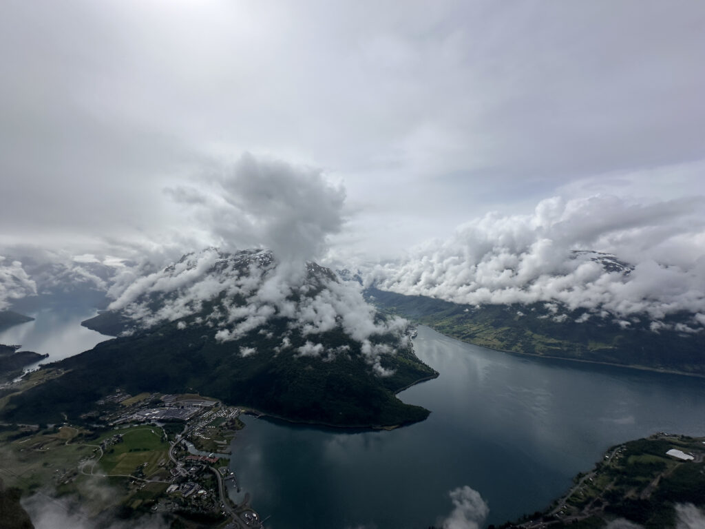 a body of water with clouds above it