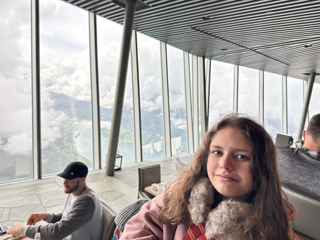 a girl taking a selfie in a room with a window
