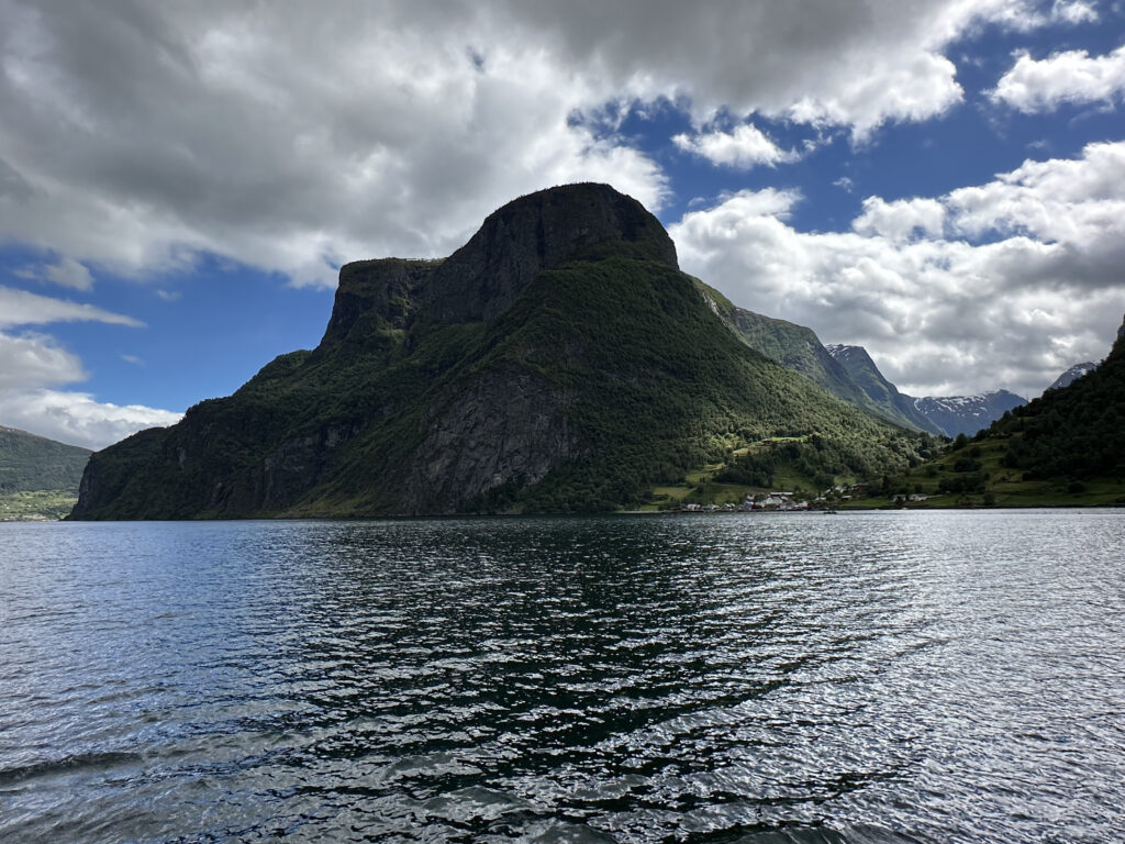 a mountain next to a body of water