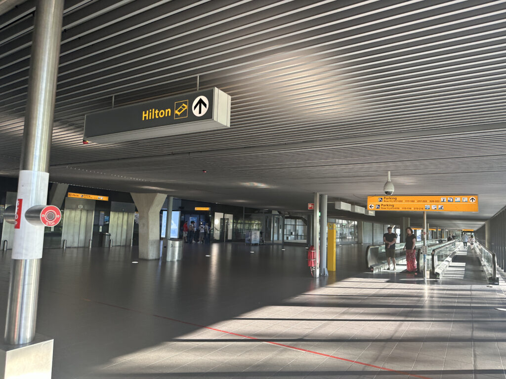 a large airport terminal with people walking and walking