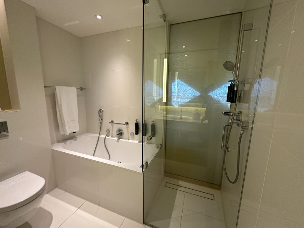 a bathroom with a glass shower door
