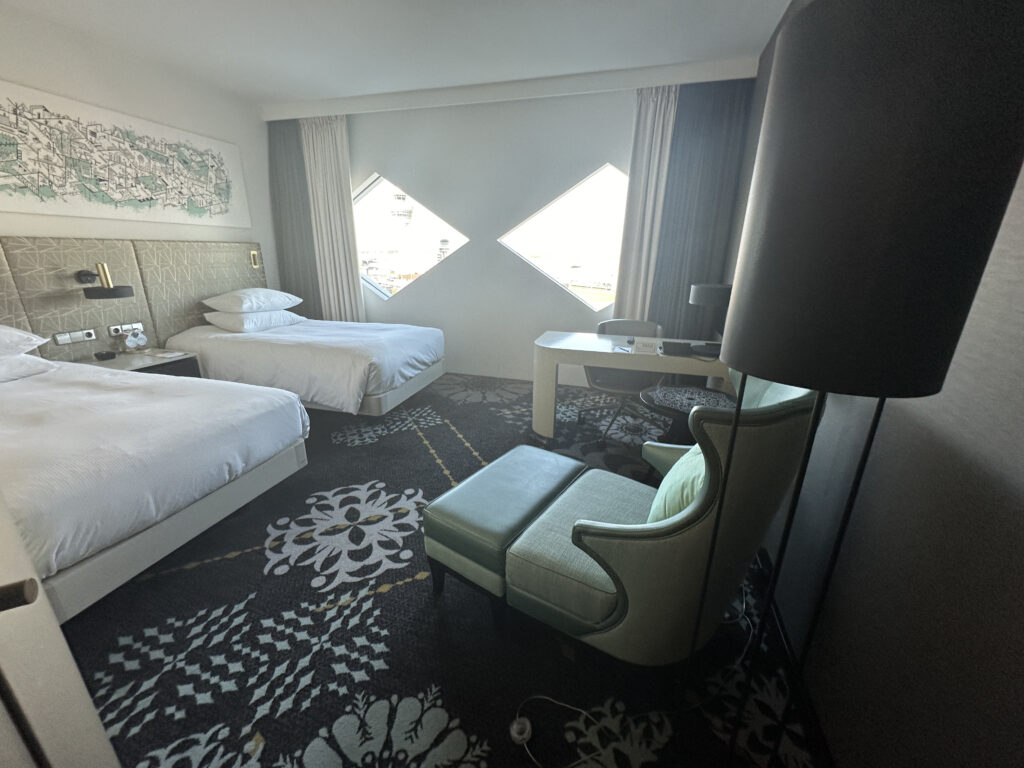 a room with two beds and a lamp