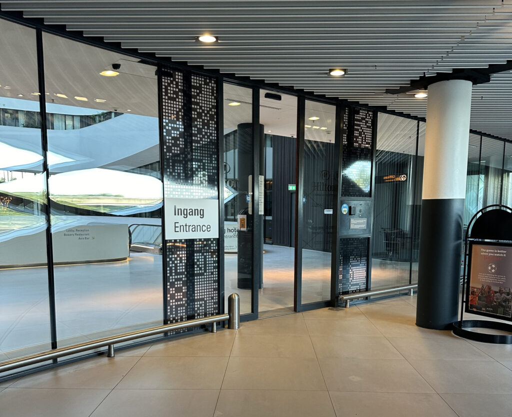 a glass wall with a sign in front of it