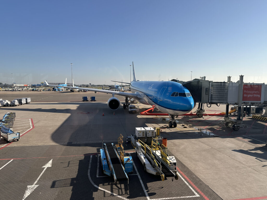 a blue airplane on a tarmac