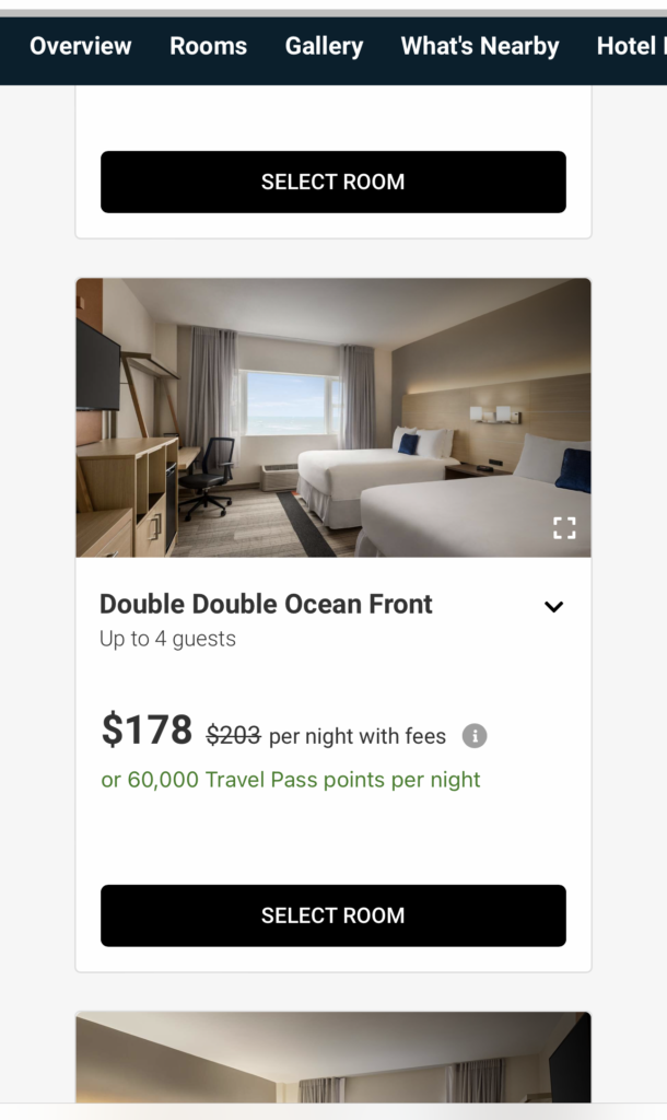 screenshot of a hotel room with a bed and a desk