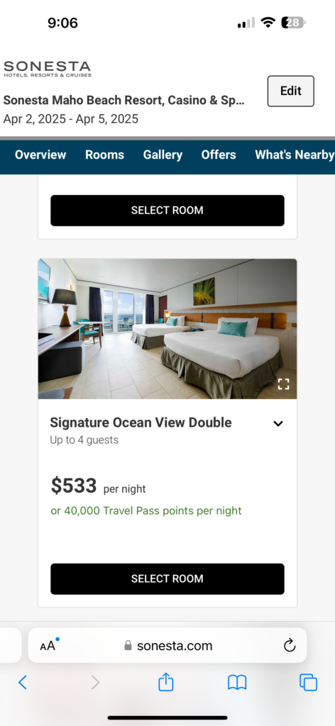 screenshot of a hotel room with beds and a table