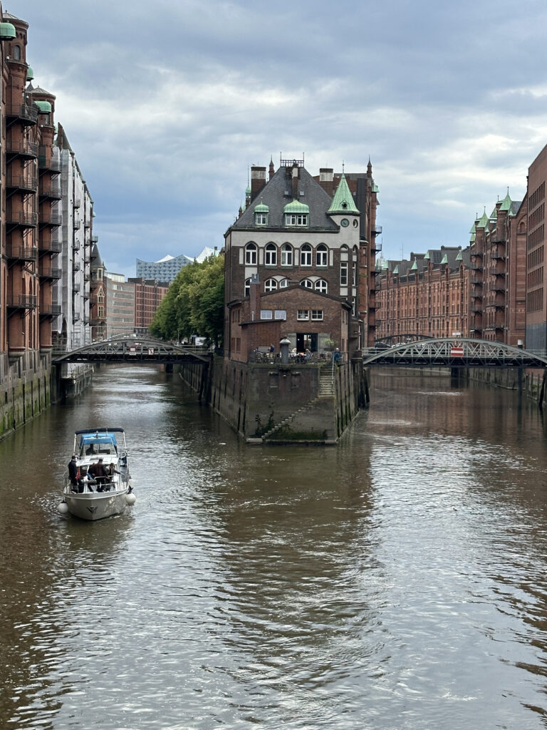 a boat on a river with buildings in the background