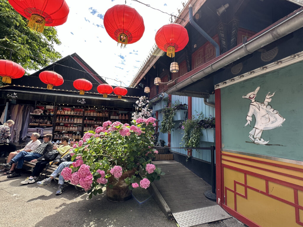 a building with red lanterns and flowers
