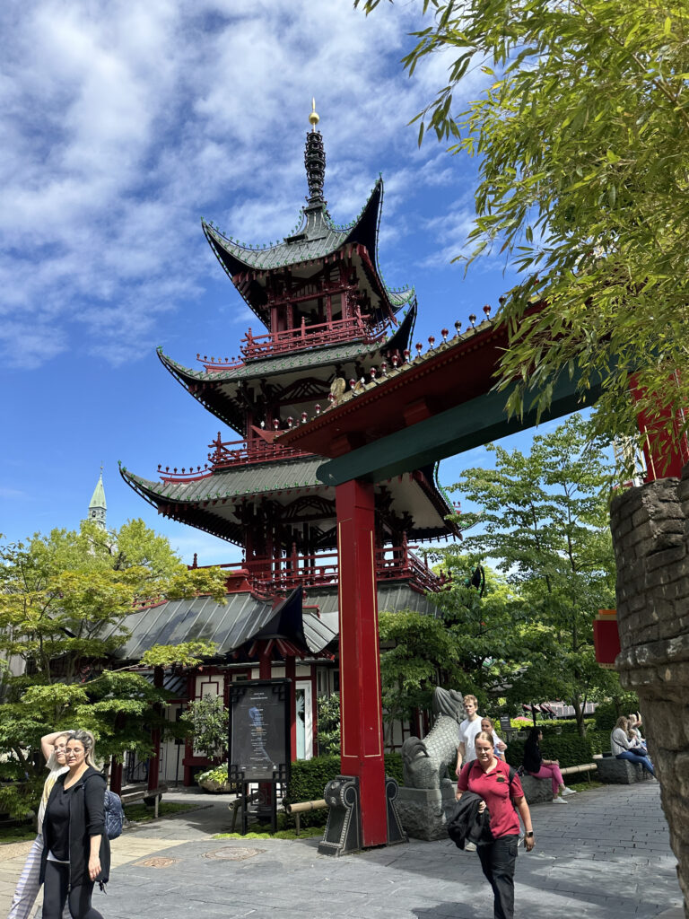 a group of people in front of a pagoda