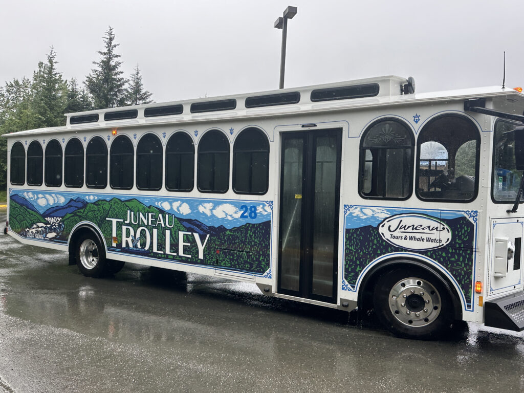 a white bus with blue and white graphics