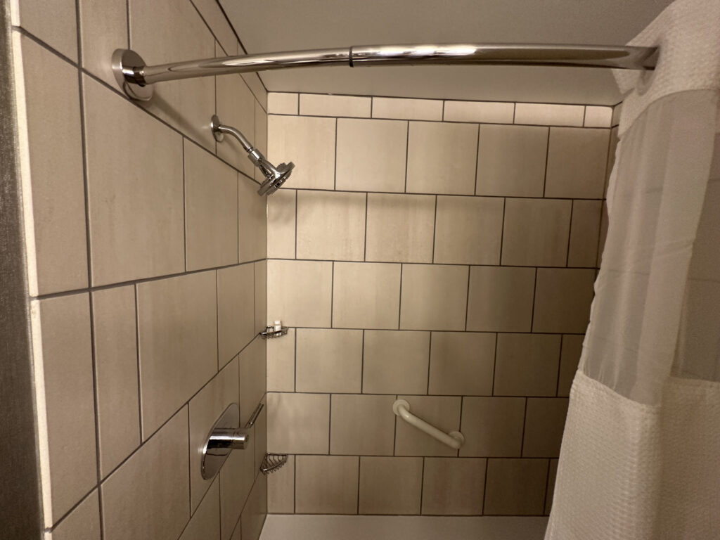 a shower with a shower head and shower head