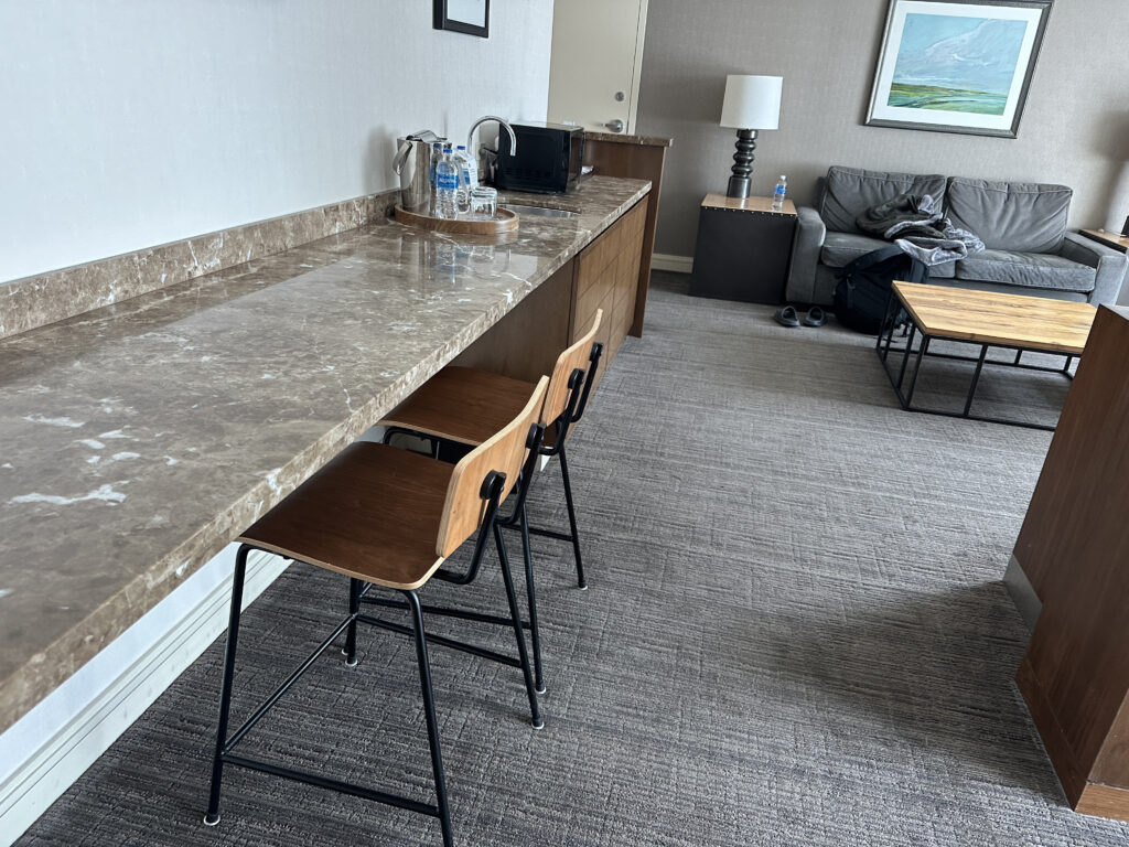 a room with a counter and chairs