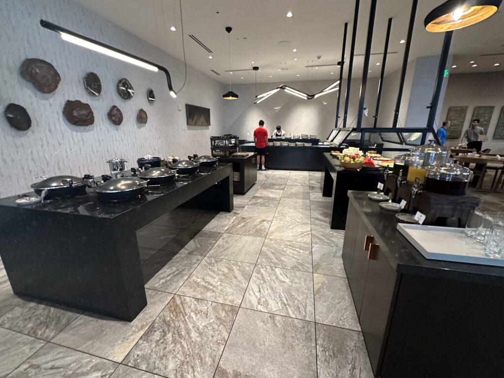 a large room with black counter tops and black pans