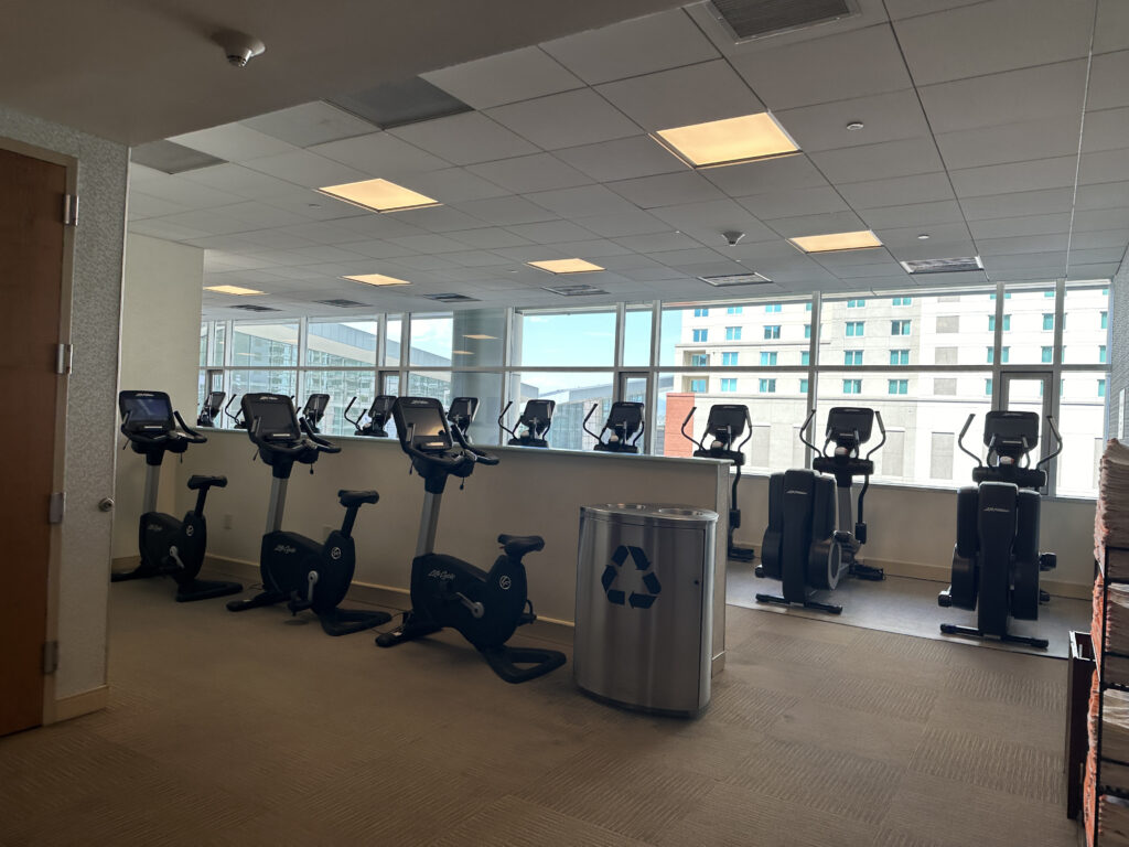 a room with exercise bikes and a large window