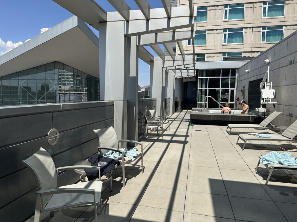a building with a pool and chairs
