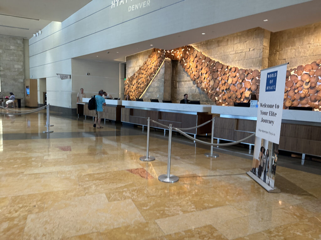 a lobby with a reception desk and rope barriers