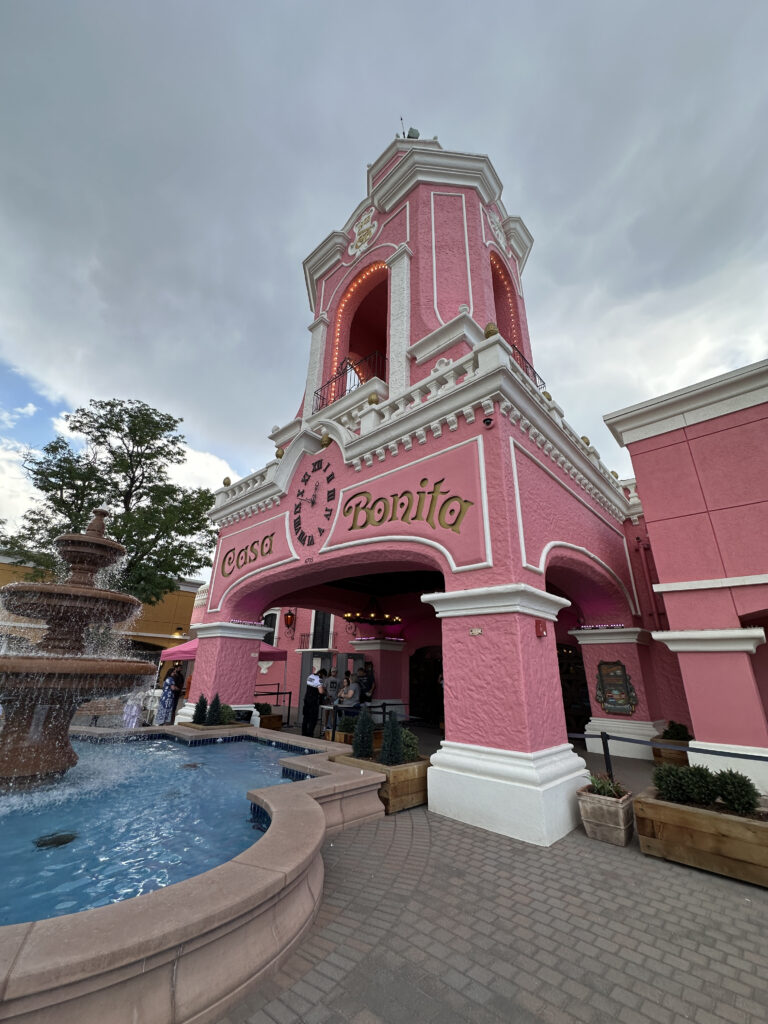 a pink building with a fountain