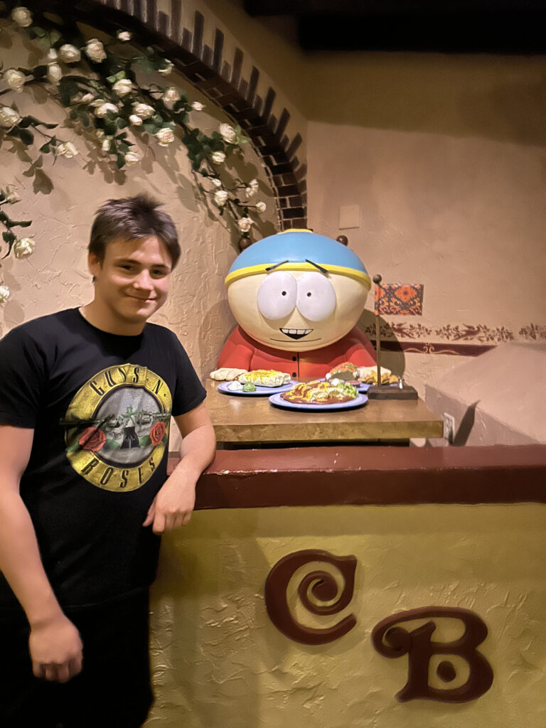 a man standing next to a cartoon character