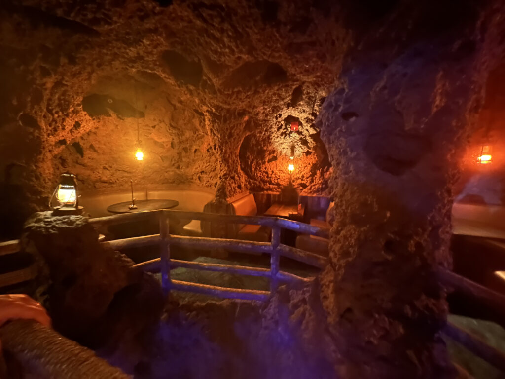 a cave with a railing and lights