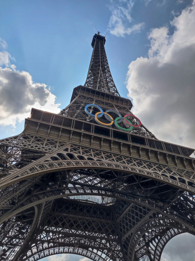 a large metal tower with olympic rings on top